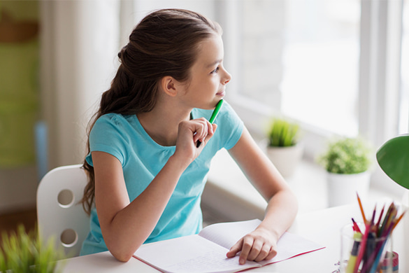 a girl pauses and thinks during her homework